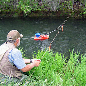 man using technical equipment in river
